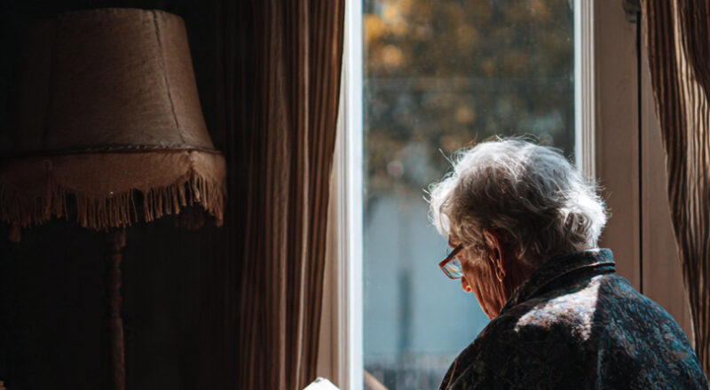 Senior woman feeling lonely at home - importance of home safety and daily check-ins for elderly living alone 2026